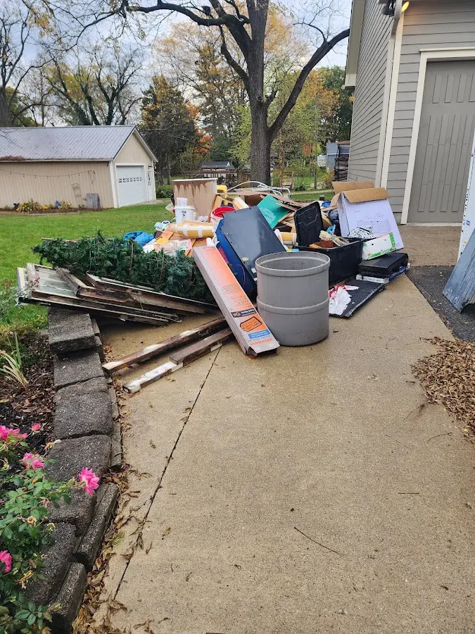 Dumpster being loaded with debris for Estate Cleanout Dumpster Rental in Ilchester